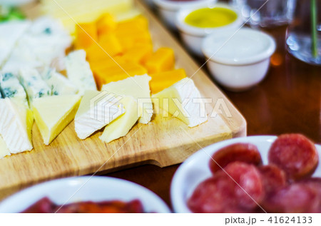 set of different cheeses on a wooden board 41624133