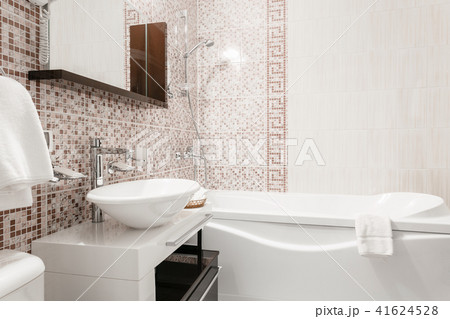 Bathroom Inside rooms of a apartment or hotel. Clean white towel and bathrobe on a hanger prepared Bathroom Inside rooms of a apartment or hotel. Clean white towel and bathrobe on a hanger prepared 41624528