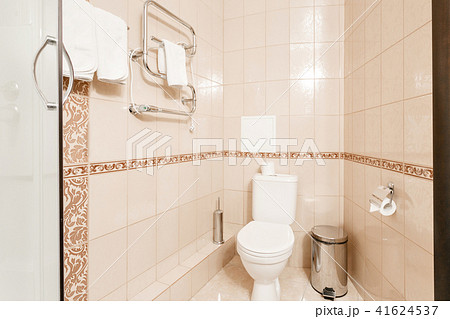 Bathroom Inside rooms of a apartment or hotel. Clean white towel and bathrobe on a hanger prepared 41624537