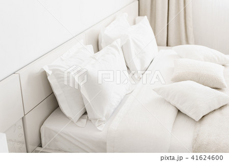 Modern double bedroom. Comfortable soft white pillows on a bed. Inside rooms of a apartment or hotel Modern double bedroom. Comfortable soft white pillows on a bed. Inside rooms of a apartment or hotel 41624600