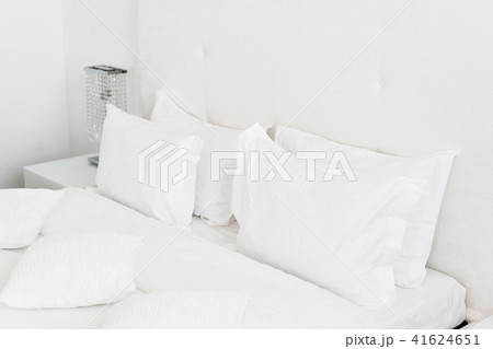 Modern double bedroom. Comfortable soft white pillows on a bed. Inside rooms of a apartment or hotel 41624651