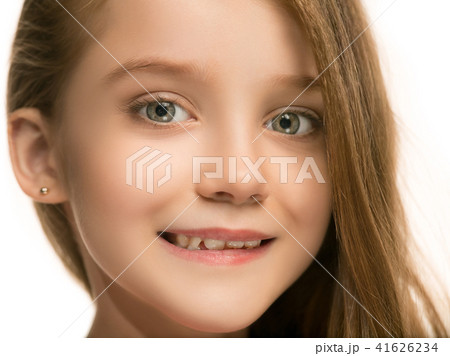 The happy teen girl standing and smiling against white background. 41626234