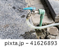 Garden hose or white rubber tube with faucet on gr 41626893
