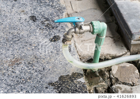 Garden hose or white rubber tube with faucet on gr Garden hose or white rubber tube with faucet on gr 41626893