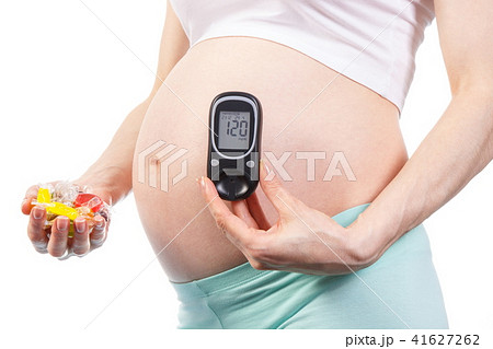 Pregnant woman with glucose meter Pregnant woman with glucose meter 41627262