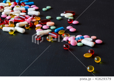 Different colorful medicines. Pills and capsules on black background. Copy space. 41629379