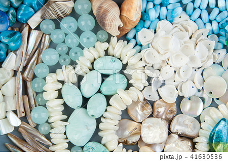 Gray plate with beads and seashells Gray plate with beads and seashells 41630536