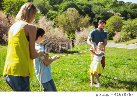 Happy family playing a game in the park Happy family playing a game in the park 41630767