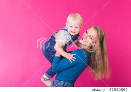 Funny family on pink background. Mother and her daughter girl. Mom and child are having fun. Funny family on pink background. Mother and her daughter girl. Mom and child are having fun. 41630862