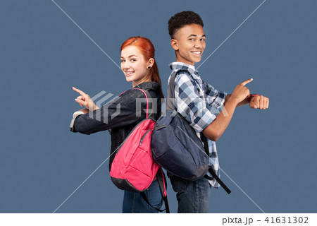 Happy joyful people pointing at their smartwatches Happy joyful people pointing at their smartwatches 41631302