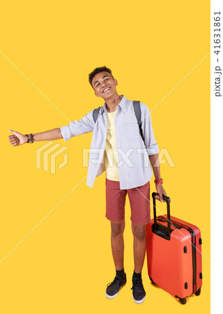 Cheerful happy man hitch hiking Cheerful happy man hitch hiking 41631861