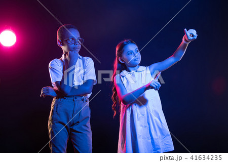 Cheerful girl pressing imaginary buttons 41634235