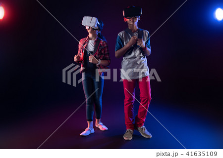 Delighted schoolchildren playing VR games together 41635109