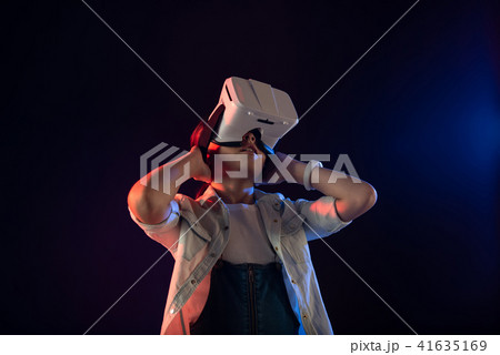 Serious girl wearing a VR headset 41635169