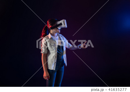 Happy schoolgirl wearing a VR headset 41635277