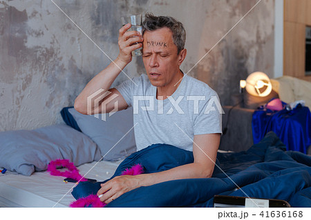 Jagged mature man experiencing headache 41636168