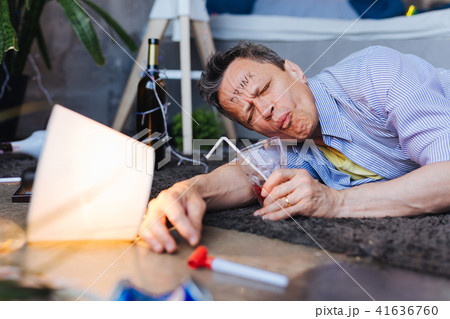 Displeased mature man damaging his health Displeased mature man damaging his health 41636760