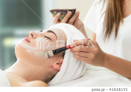 Beautiful woman having a facial treatment at spa. 41638155