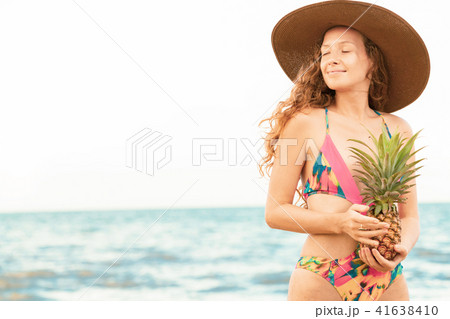 Happy woman wearing swimsuit on beach in summer Happy woman wearing swimsuit on beach in summer 41638410