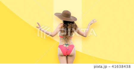 Woman in swimsuit posing on color background. 41638438