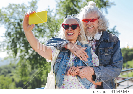 Nice cheerful woman holding her smartphone 41642643
