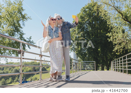 Happy nice couple taking photos on the bridge Happy nice couple taking photos on the bridge 41642700