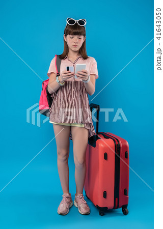 Serious girl standing with her phone Serious girl standing with her phone 41643050
