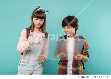 Alert schoolchildren holding a screen 41643621