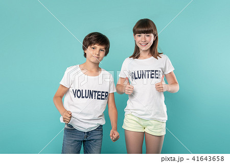 Alert young volunteers showing thumbs up 41643658