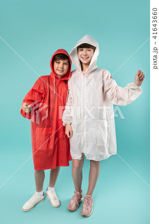 Smiling kids wearing lovely raincoats 41643660