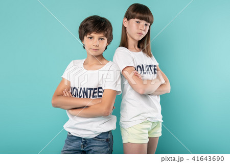 Serious volunteers standing with their arms crossed 41643690