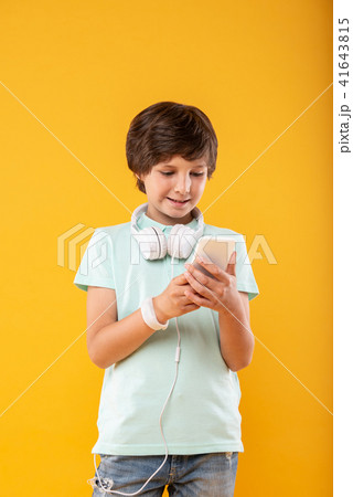Delighted boy using his modern phone 41643815