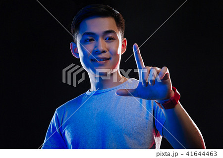 Cheerful positive man looking at his finger 41644463