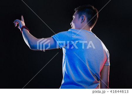 Cheerful happy teenager working on the transparent screen Cheerful happy teenager working on the transparent screen 41644613