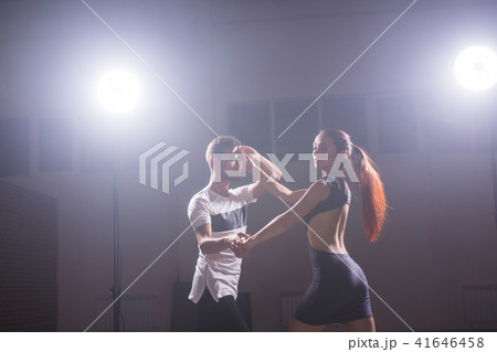 Young couple dancing latin dance Bachata, merengue, salsa. Two elegance pose in dance class Young couple dancing latin dance Bachata, merengue, salsa. Two elegance pose in dance class 41646458