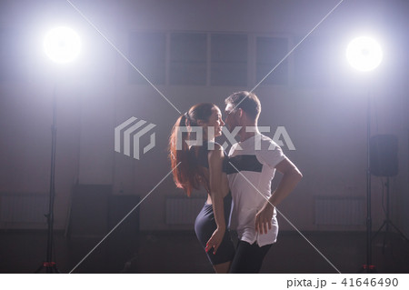 Young couple dancing social danse kizomba or bachata or semba or taraxia in dancing class background Young couple dancing social danse kizomba or bachata or semba or taraxia in dancing class background 41646490