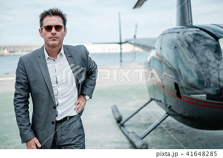 Businessman near private helicopter Businessman near private helicopter 41648285