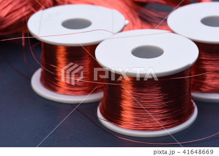 Copper electric coil and wire on metal background 41648669