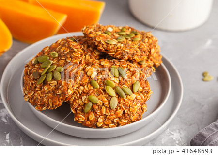 Fresh oatmeal pumpkin cookies on a gray plate Fresh oatmeal pumpkin cookies on a gray plate 41648693