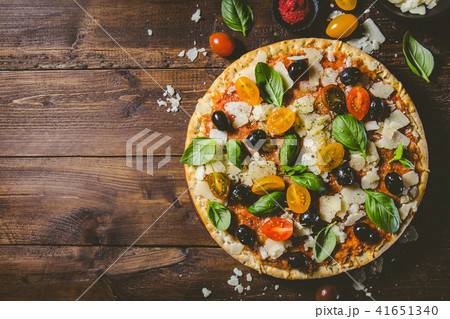 Traditional italian pizza on wooden table Traditional italian pizza on wooden table 41651340