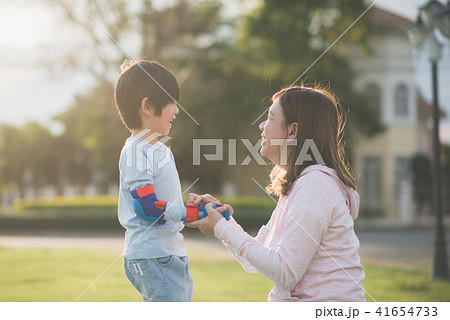 mother helping her son putting hand protectors 41654733