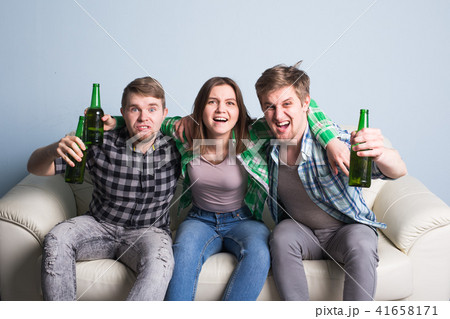 Happy friends or football fans watching soccer on tv and celebrating victory. Friendship, sports and Happy friends or football fans watching soccer on tv and celebrating victory. Friendship, sports and 41658171