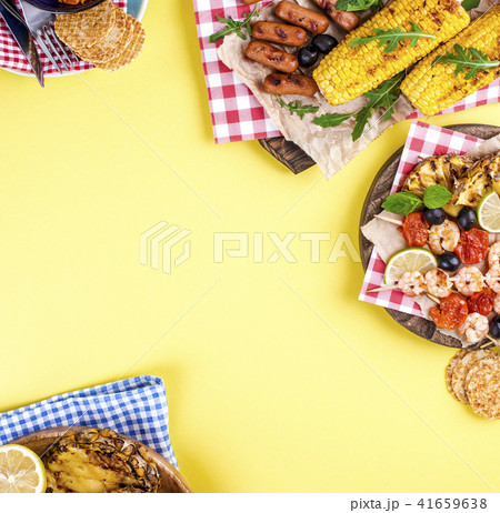 Different fruits and vegetables on grilled and shrimp. Yellow background. Summer dinner. . Copy 41659638