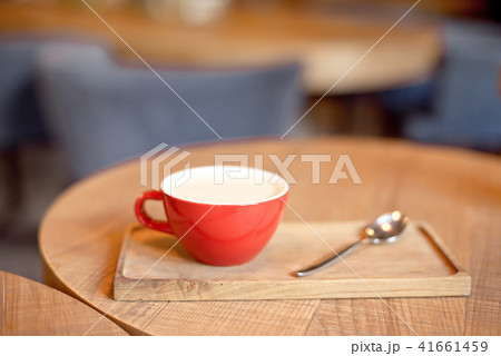 coffee cup on wooden tray in modern cafe interior with blurred background. 41661459