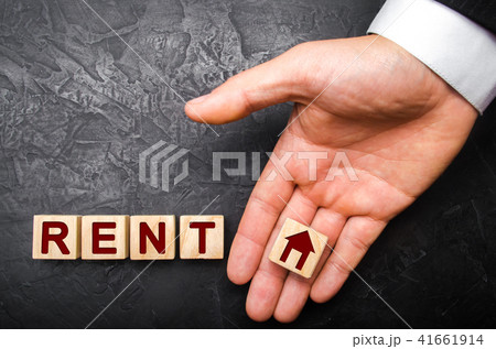 a cube on the palm with a picture of the house a cube on the palm with a picture of the house 41661914