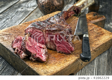 Barbecue dry aged Wagyu Tomahawk Steak as close-up Barbecue dry aged Wagyu Tomahawk Steak as close-up 41662229