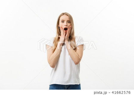 Lifestyle Concept: Portrait of happy blond surprised young woman on white background. 41662576