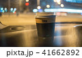 a cup of coffee is on the dashboard of the car 41662892