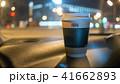 a cup of coffee is on the dashboard of the car 41662893