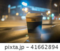 a cup of coffee is on the dashboard of the car 41662894